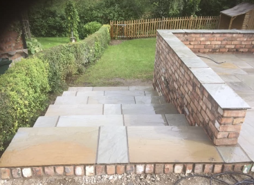 Raised Sandstone Terrace with Brick Wall